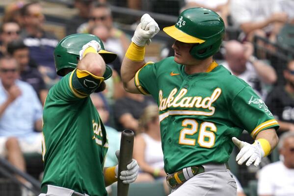 Oakland Athletics' Matt Chapman, right, celebrates with Seth Brown after hitting a solo home run during the sixth inning of a baseball game in Chicago, Thursday, Aug. 19, 2021. (AP Photo/Nam Y. Huh)