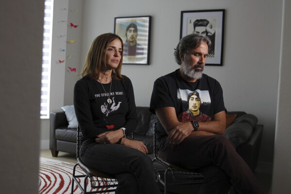 Manuel and Patricia Oliver, the parents of Joaquin Oliver, one of the victims of the 2018 mass shooting at Marjory Stoneman Douglas High School in Parkland, Fla., sit for an interview in Coral Springs, Fla., on Friday Feb. 9, 2024. The Olivers are launching a campaign where re-created voices of gun violence victims will call federal lawmakers. The recordings re-creating voices of victims from around the country are being robocalled to U.S. senators and House members who oppose stricter gun laws. (APPhoto/Cody Jackson)