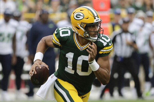 Green Bay Packers quarterback Jordan Love (10) scrambles up field in the first half of a preseason NFL football game against the Seattle Seahawks, Saturday, Aug. 26, 2023, in Green Bay, Wis. (AP Photo/Mike Roemer)