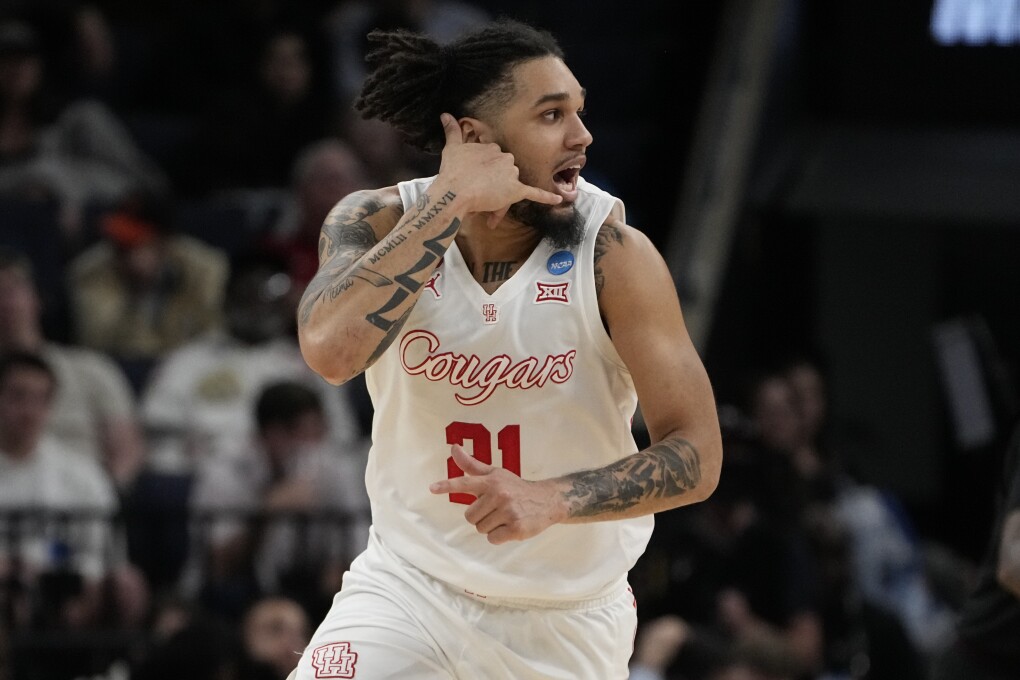 Houston guard Emanuel Sharp (21) celebrates a three-point basket during the second half of a second-round college basketball game against Texas A&M in the NCAA Tournament, Sunday, March 24, 2024, in Memphis, Tenn. Houston won 100-95 in overtime. (AP Photo/George Walker IV)