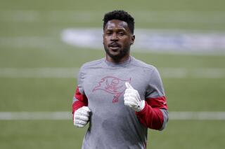 FILE - In this Sunday, Jan. 17, 2021 file photo, Tampa Bay Buccaneers wide receiver Antonio Brown warms up before the first half of an NFL divisional round playoff football game between the New Orleans Saints and the Tampa Bay Buccaneers in New Orleans. NFL wide receiver Antonio Brown has settled a civil lawsuit by former trainer Britney Taylor, who accused Brown of sexually assaulting her. Taylor filed the lawsuit in 2019, and lawyers for her and Brown released statements Wednesday, April 21, 2021 revealing the agreement. (AP Photo/Brett Duke, File)
