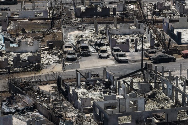 FILE - A general view shows the aftermath of a devastating wildfire in Lahaina, Hawaii, Aug. 22, 2023. Federal authorities have started removing hazardous materials from the Maui wildfires and laying the groundwork to dispose of burnt cars, buildings and other debris. The hazardous materials, including oil, solvent and batteries, are being shipped to the West Coast while the U.S. Army Corps of Engineers works with local officials to develop a plan to dispose of an estimated 400,000 to 700,000 tons of debris on the island. (AP Photo/Jae C. Hong, File)