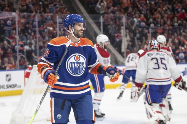 Edmonton Oilers' Adam Henrique (19) celebrates a goal against the Montreal Canadiens during the second period of an NHL hockey game in Edmonton, Alberta, Tuesday March 19, 2024. (Jason Franson/The Canadian Press via AP)