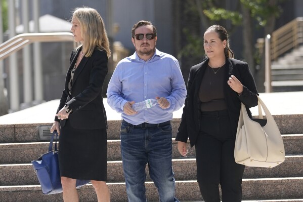 Juan Henao walks with his attorneys following a federal court hearing into the disappearance of his sister, Ana Maria Henao Knezevich, Friday, May 10, 2024, in Miami. Her husband, David Knezevich was denied bond after he was arrested and charged with kidnapping her from an apartment in Spain. (AP Photo/Marta Lavandier)
