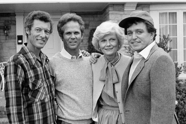 FILE - This Dec. 10, 1982 file photo shows members of the original cast of the "Leave It To Beaver," from left,  Ken Osmond, Tony Dow, Barbara Billingsley and Jerry Mathers during the filming of their TV special, "Still The Beaver," in Los Angeles. Osmond, who played the two-faced teenage scoundrel Eddie Haskell on TV’s “Leave it to Beaver,” has died. Osmond's family says he died Monday, May 18, 2020, in Los Angeles. He was 76. (AP Photo/Wally Fong, File)