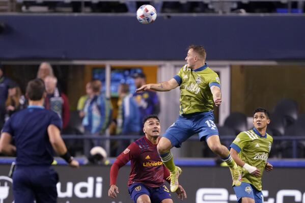 Seattle Sounders' Jordan Morris leaps to head the ball as Real Salt Lake's Marcelo Silva watches during the first half of an MLS first-round playoff soccer match Tuesday, Nov. 23, 2021, in Seattle. (AP Photo/Ted S. Warren)