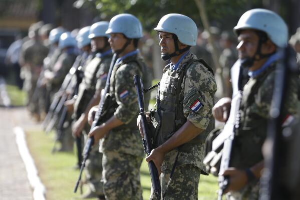 FILE - Soldiers line up at the United Nations Peace Operations Training Center (CECOPAZ) before the arrival of United Nations Secretary-General Ban Ki-Moon in Asuncion, Paraguay, on Feb. 26, 2015. The organization is marking the 75th anniversary of U.N. peacekeeping and observing the International Day of United Nations Peacekeepers on Thursday, May 25, 2023. (AP Photo/Jorge Saenz, File)