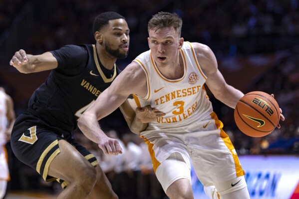 Tennessee guard Dalton Knecht (3) drives as Vanderbilt guard Isaiah West (4) defend during the first half of an NCAA college basketball game Saturday, Feb. 17, 2024, in Knoxville, Tenn. (APPhoto/Wade Payne)
