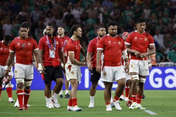 Tonga players walk around the pitch after the Rugby World Cup Pool B match between Ireland and Tonga at the Stade de la Beaujoire in Nantes, France, Saturday, Sept. 16, 2023. Ireland won the match 59-16. (AP Photo/Jeremias Gonzalez)