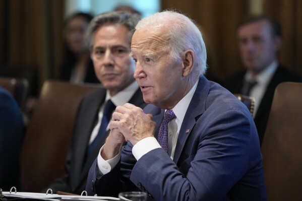 FILE - President Joe Biden speaks during a meeting with his Cabinet in the Cabinet Room of the White House in Washington, Monday, Oct. 2, 2023. Secretary of State Antony Blinken looks on at left. The deadly Hamas militant attack on Israel and the massive retaliation it provoked from Jerusalem have thrust President Joe Biden into a Middle East crisis that risks expanding into a broader conflict and has left him fending off criticism from GOP presidential rivals that his administration's policies led to this moment. (AP Photo/Susan Walsh, File)