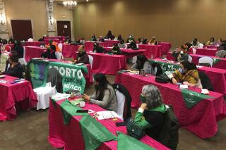 FILE - Mexican and U.S. abortion advocates gather on day two of a three day meeting to discuss their coordinated efforts to support women in the U.S. seeking abortion services under increasingly restrictive state laws, in Matamoros, Mexico, Jan. 21, 2022. Networks of Mexican feminist collectives working with counterparts in the United States are ramping up their efforts to help women in the U.S. who have lost access to abortion services to end their pregnancies after the U.S. Supreme Court overturned the landmark decision that gave women the right to access abortion on June 24, 2022.  (AP Photo/Maria Verza, File)