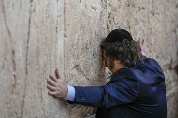 FILE- Argentine President Javier Milei prays at the Western Wall in Jerusalem's Old City, Feb. 6, 2024. Although born and raised Roman Catholic, Milei has increasingly shown public interest in Judaism and even expressed intentions to convert. (AP Photo/Leo Correa, File)