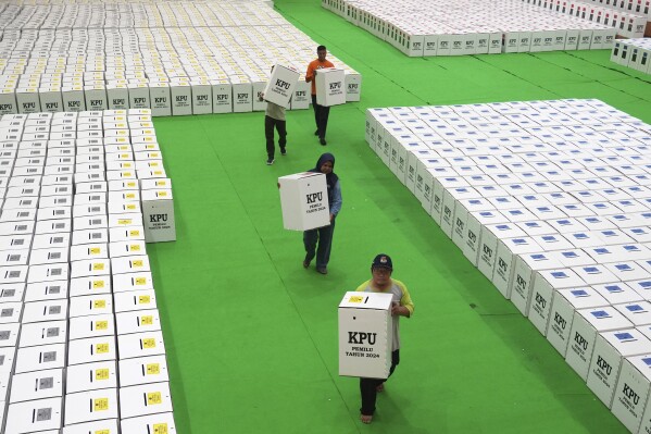 Workers arrange ballot boxes prepared for the 2024 election and temporary stored at a stadium in Jakarta, Indonesia, Tuesday, Dec. 26, 2023. The world's third-largest democracy is gearing up to hold its legislative and presidential elections on Feb. 14, 2024. (AP Photo/Tatan Syuflana)