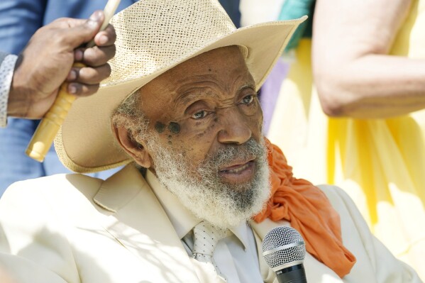 Undaunted after falling on top of an unsecured lectern, political activist and writer James Meredith speaks to a small assembly attending the celebratory end of his 200 mile walk against crime on his 90th birthday at the Mississippi Capitol in Jackson, Miss., Sunday, June 25, 2023. (AP Photo/Rogelio V. Solis)