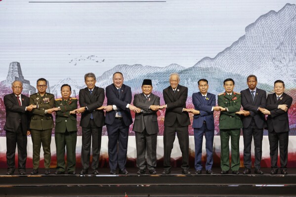 From left, Brunei's Second Minister of Defense Halbi Mohd Yusof, Cambodia's Defense Minister Tea Seiha, Laos' Defense Minister Chansamone Chanyalath, Malaysia's Defense Minister Mohamad Hasan, Philippine's Defense Secretary Gilbert Teodoro, Indonesia's Defense Minister Prabowo Subianto, Singapore's Defense Minister Ng Eng Hen, Thailand's Defense Minister Sutin Klungsang, Vietnam's Defense Minister Phan Van Giang, East Timor's Defense Minister Donaciano Do Rosario Da Costa Gomes and ASEAN Secretary General Kao Kim Hourn hold hands as they pose for a family photo during the Association of Southeast Asian Nations (ASEAN) Defense Ministers Meeting in Jakarta, Indonesia, Wednesday, Nov. 15, 2023. (Mast Irham/Pool Photo via AP)