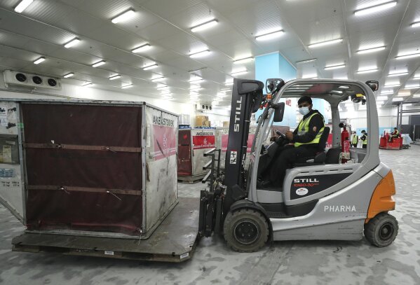 A Pfizer-BioNTech COVID-19 coronavirus vaccine shipment is offloaded into a refrigerated storage space at Dubai International Airport cargo terminal, in Dubai, United Arab Emirates, early Sunday, Feb. 21, 2021. As the coronavirus pandemic continues to clobber the aviation industry, Emirates Airlines, the Middle East’s biggest airline is seeking to play a vital role in the global vaccine delivery effort. (AP Photo/Kamran Jebreili)