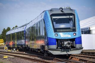 A hydrogen-powered regional train stands at Bremervoerde station, Germany, Wednesday, Aug. 24, 2022. In the fight against climate change, 14 hydrogen trains are to replace the current diesel trains. In Bremervoerde, a trial operation with two prototypes ran successfully between fall 2018 and February 2020. (Sina Schuldt/dpa via AP)