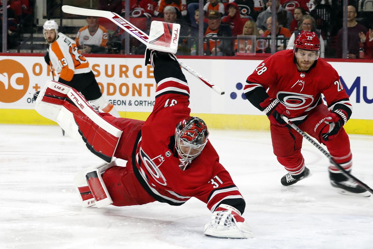 Carolina Hurricanes' Andrei Svechnikov (37) moves the puck after taking it  away from Philadelphia Flyers' Claude Giroux (28) during the second period  of an NHL hockey game in Raleigh, N.C., Saturday, March
