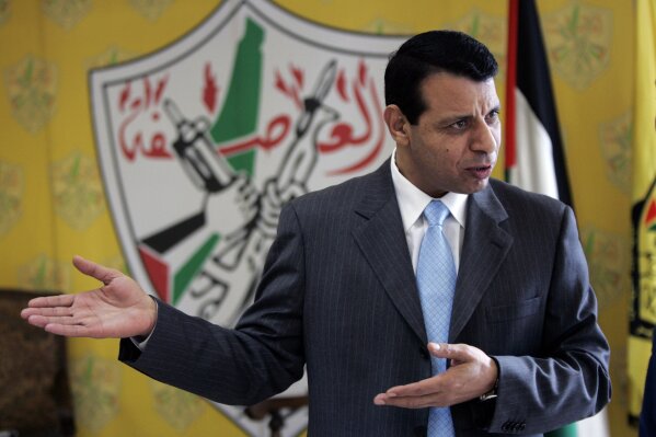 FILE - In this Jan. 3, 2011 file photo, Mohammed Dahlan speaks during an interview at his office in the West Bank city of Ramallah. Palestinian security forces have detained dozens of supporters of the rival to President Mahmoud Abbas who is based in the United Arab Emirates. Dahlan, a former senior Palestinian official who was banished from the West Bank in 2010 after a falling-out with Abbas, has denied any role in the UAE’s agreement to normalize ties with Israel, which the Palestinians view as a betrayal of their cause. His political movement said Monday, Sept. 21, 2020 that dozens of its members have been detained or summoned for questioning by Palestinian security forces in the West Bank in recent days. (AP Photo/Majdi Mohammed, File)