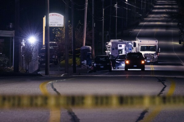 Police tape cordons off the road to Schemengees Bar and Grille as law enforcement officers maintain their presence in the aftermath of a mass shooting by Army reservist Robert Card in Lewiston, Maine, Oct. 27, 2023.  (AP Photo/Matt Rourke, File)