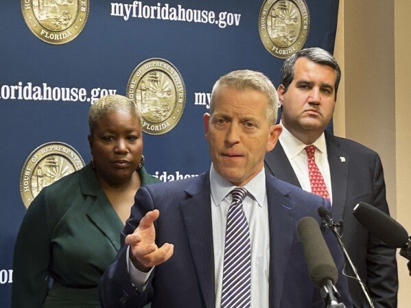 Florida's Republican House Speaker Paul Renner discusses Gov. Ron DeSantis' veto of a bill that would have banned kids under 16 from social media regardless of parental consent, in Tallahassee, Fla., Friday, March 1, 2024. A new proposal lowers that age to 14. He was joined by Democratic Rep. Michele Rayner, left, and Republican Rep. Tyler Sirois, right. (AP Photo/Brendan Farrington)