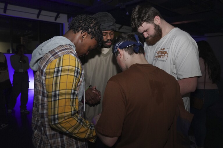 Young clubbers at The Cove, a pop-up, 18-and-up Christian nightclub, pray together after a night of dancing on Saturday, Feb. 17, 2024, in Nashville, Tenn. (AP Photo/Jessie Wardarski)