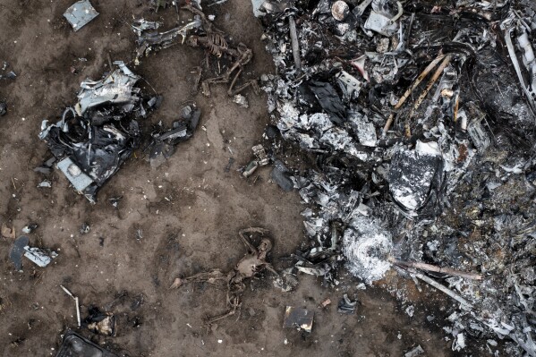 EDS NOTE: GRAPHIC CONTENT - The remains of victims and the fragments of a Russian military helicopter can be seen near Makariv, close to Kyiv, Ukraine, Saturday, April 9, 2022. (AP Photo/Efrem Lukatsky)