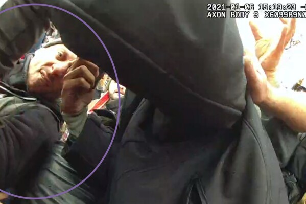 This image from the body-worn camera of Washington Metropolitan Police Department officer Michael Fanone shows Thomas Sibick, circled by the Justice Department, at left, during the riot at the U.S. Capitol on Jan. 6. Sibick, of Buffalo, who stole a badge and radio from a police officer brutally beaten by other rioters during the attack on the U.S. Capitol was sentenced on Friday to more than four years in prison. (Justice Department via AP)