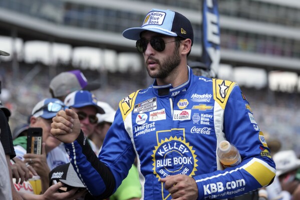 Chase Elliott walks and greets fans during introductions before a NASCAR Cup Series auto race at Texas Motor Speedway in Fort Worth, Texas, Sunday, Sept. 24, 2023. (AP Photo/LM Otero)