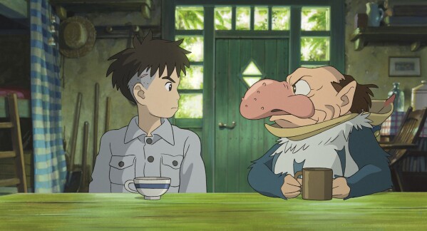 This image released by GKIDS shows Mahito Maki, voiced by Luca Padovan in English and Soma Santoki in Japanese, left, and Grey Heron, voiced by Robert Pattinson in English and Masaki Suda in Japanese, in a scene from Hayao Miyazaki’s “The Boy And The Heron." (Studio Ghibli/GKIDS via AP)
