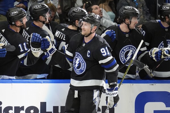 Tampa Bay Lightning center Steven Stamkos (91) celebrates his goal against the New York Islanders with the bench during the third period of an NHL hockey game Saturday, March 30, 2024, in Tampa, Fla. (AP Photo/Chris O'Meara)
