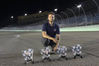 
              This Nov. 18, 2018, photo provided by Bryan Blackford and Snowcone Productions shows Ray Alfalla with his awards on the track at Homestead-Miami Speedway in Homestead, Fla. Alfalla is in the elite class of drivers who have mastered virtual iRacing, an online simulation of the real deal each week in NASCAR. (Bryan Blackford/Snowcone Productions via AP)
            