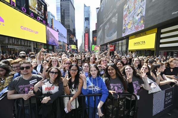 Fans gather for the Italian rock group Måneskin perform in Times Square on Friday, Sept. 15, 2023, in New York. (Photo by Evan Agostini/Invision/AP)
