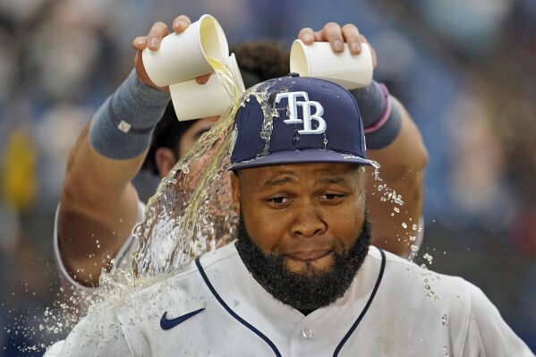 Tampa Bay Rays' Manuel Margot gets gatorade poured on his head after his walk-off single against Los Angeles Angels relief pitcher Carlos Estevez during the ninth inning of a baseball game Thursday, Sept. 21, 2023, in St. Petersburg, Fla. (AP Photo/Chris O'Meara)