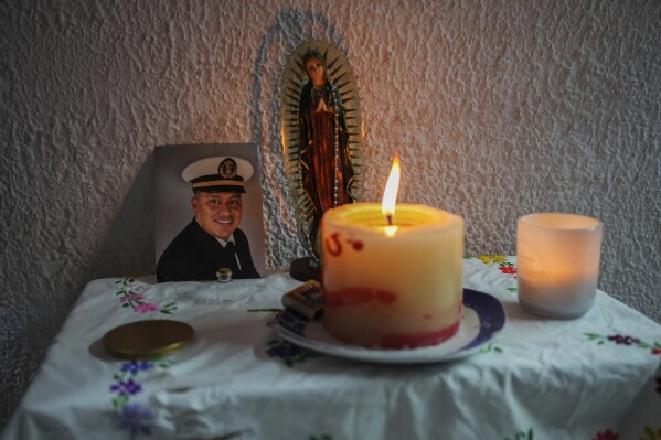 A photo of Arturo Zacarias Meza, a crew member of the cargo ship Galaxy Leader, adorns an altar, in Misantla, Mexico, Tuesday, Nov. 21, 2023. Meza is one of 25 crew members of the ship Galaxy Leader who have been held hostage by Yemeni Houthi rebels since the group seized their Israel-linked vessel while it was sailing along a major shipping lane in the Red Sea. The armed group said it will continue attacking vessels linked to Israel and in international waters until its war against Hamas ends. (AP Photo/Felix Marquez)