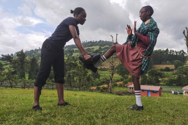 I'm Worth Defending officer Amelia Awuor, left, demonstrates self-defense techniques at Enkakenya Centre for Excellence in Narok County, Kenya, on Feb. 1, 2025. (AP Photo/Nicholas Komu)