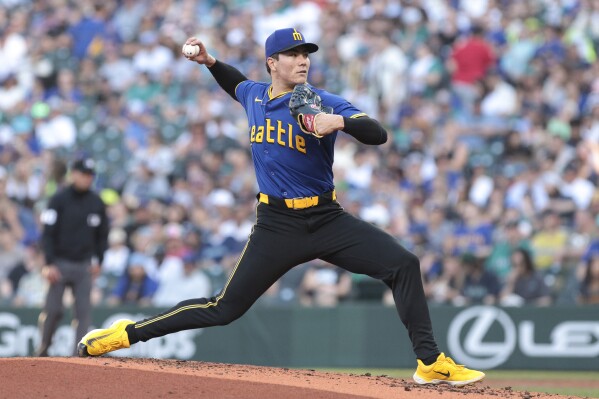 Seattle Mariners starting pitcher Bryan Woo throws during the third inning of a baseball game against the Oakland Athletics, Friday, May 10, 2024, in Seattle. (AP Photo/Jason Redmond)