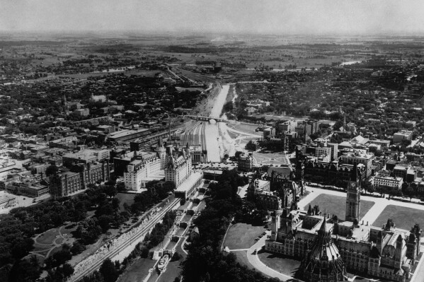 A view of Ottawa, the capital of the dominion of Canada on May 17, 1939, where King George VI and Queen Elizabeth will stay. In the right foreground is the Federal Parliament buildings, surrounded by their spacious lawns, to the left are the locks connecting the Rideau Canal, in background, with the Ottawa River, and just above the locks is the Union Railway Station. (ĢӰԺ Photo)