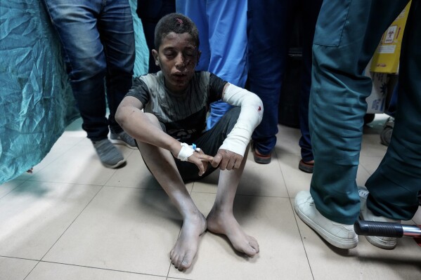 A Palestinian child wounded in the Israeli bombardment of the Gaza Strip waits for the treatment at Al Aqsa hospital in Deir al Balah, central Gaza Strip, on Sunday, May 26, 2024. (AP Photo/Abdel Kareem Hana)
