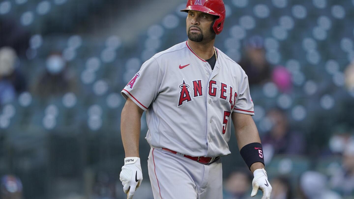 Los Angeles Angels of Anaheim's Albert Pujols slaps hands with opposing  team players before the start of Albert's All-Star basketball game at  Missouri Baptist University in Town and Country on January 29