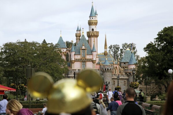 
              FILE - In this Jan. 22, 2015, file photo, visitors walk toward Sleeping Beauty's Castle in the background at Disneyland Resort in Anaheim, Calif. A health official testified that a cooling tower that provides mist to make Disneyland visitors comfortable was the likely source for 22 cases in a Legionnaires' disease outbreak in 2017 near the theme park. Dr. Matthew Zahn with the Orange County Health Care Agency testified Tuesday, Dec. 4, 2018, before an appeals board judge at the California Occupational Safety and Health Administration. (AP Photo/Jae C. Hong, File)
            