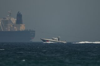 
              An Emirati coast guard vessel passes an oil tanker off the coast of Fujairah, United Arab Emirates, Monday, May 13, 2019. Saudi Arabia said Monday two of its oil tankers were sabotaged off the coast of the United Arab Emirates near Fujairah in attacks that caused "significant damage" to the vessels, one of them as it was en route to pick up Saudi oil to take to the United States. (AP Photo/Jon Gambrell)
            