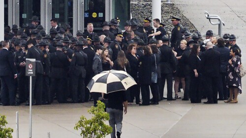 Mourners line up for the funeral for Pennsylvania State Police trooper Jacques Rougeau Jr. at the Bayfront Convention Center, Tuesday, June 27, 2023, in Erie, Pa., Tuesday, June 27, 2023. Rougeau Jr., 29, was killed and Lt. James Wagner, 45, was critically wounded in separate encounters before Brandon Stine, 38, of Thompsontown, was killed Saturday, June 17, police said. (Greg Wohlford/Erie Times-News via AP)