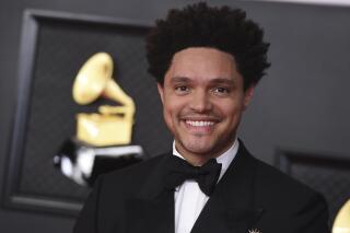 FILE - Trevor Noah appears at the 63rd annual Grammy Awards in Los Angeles on March 14, 2021. Noah will host the 64th annual Grammy Awards on April 3. (Photo by Jordan Strauss/Invision/AP, File)