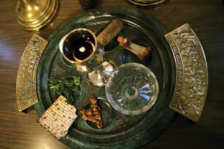 FILE - In this April 2, 2006, file photo, a traditional Passover seder plate is seen at Congregation Beth El in Tyler, Texas, on the first night of Passover. For some Jews this year, Passover Seder will connect the exodus story with today's global refugee crisis through special recitations and rituals _ and refugee guests from around the world. The foods on the plate are symbols, and help tell the story of the exodus of the Jewish people from Egypt as told in the old Testament of the Bible. (AP Photo/Dr. Scott M. Lieberman, File)