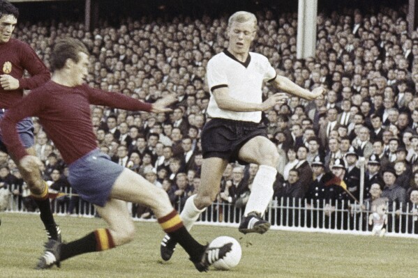 FILE - Karl-Heinz Schnellinger, right, West Germany’s defender challenges for the ball with two Spanish players during their Soccer World Cup match at Villa Park, Birmingham, England, United Kingdom on July 20, 1966. Karl-Heinz Schnellinger, who played for West Germany at four World Cups including the 1966 final, has died. He was 85. The German soccer federation and Schnellinger’s former club Cologne both confirmed Tuesday, May 21, 2024. (AP Photo/file)