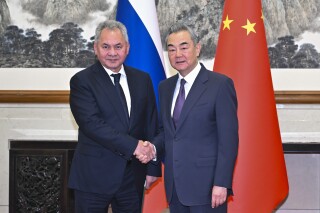 In this photo released by Xinhua News Agency, Chinese Foreign Minister Wang Yi, right, meets with Russian Security Council Secretary Sergei Shoigu during the 19th round of China-Russia strategic security consultations in Beijing on Tuesday, Nov. 12, 2024. (Yue Yuewei/Xinhua via AP)