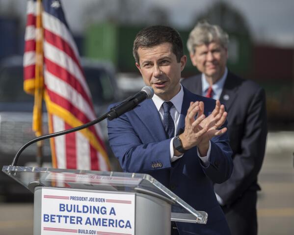 U.S. Transportation Secretary Pete Buttigieg speaks to the media during a visit to the Georgia Ports Authority's Megarail facility, Friday, Dec., 17, 2021 in Savannah, Ga.  Buttigieg used the visit to highlight the coordination with the his department and the Georgia Ports Authority to improve its cargo flow. (AP Photo/Stephen B. Morton)