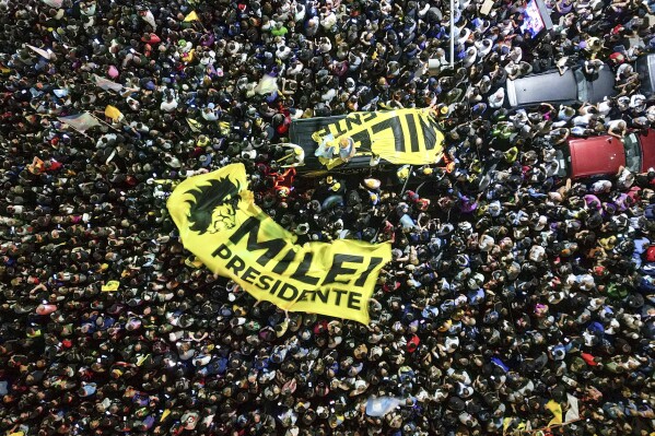 FILE - Supporters of presidential candidate Javier Milei gather outside his campaign headquarters after his opponent conceded defeat in the presidential runoff election, in Buenos Aires, Argentina, Nov. 19, 2023. Milei will be inaugurated as the new president of Argentina on Sunday, Dec. 10. (AP Photo/Matias Delacroix, File)