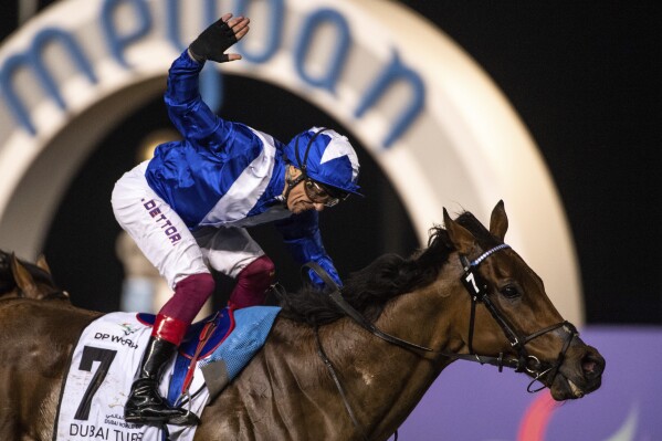 FILE - Lord North with jockey Frankie Dettori wins Group 1 Dubai Turf over 1800m (9 furlongs) at the Meydan racecourse in Dubai, United Arab Emirates, Saturday, March 25, 2023. The 52-year-old Italian jockey was set to retire at the end of 2023 but he has reversed his decision and will continue to ride horses primarily in the United States but also in the Middle East. (AP Photo/Martin Dokoupil, File)